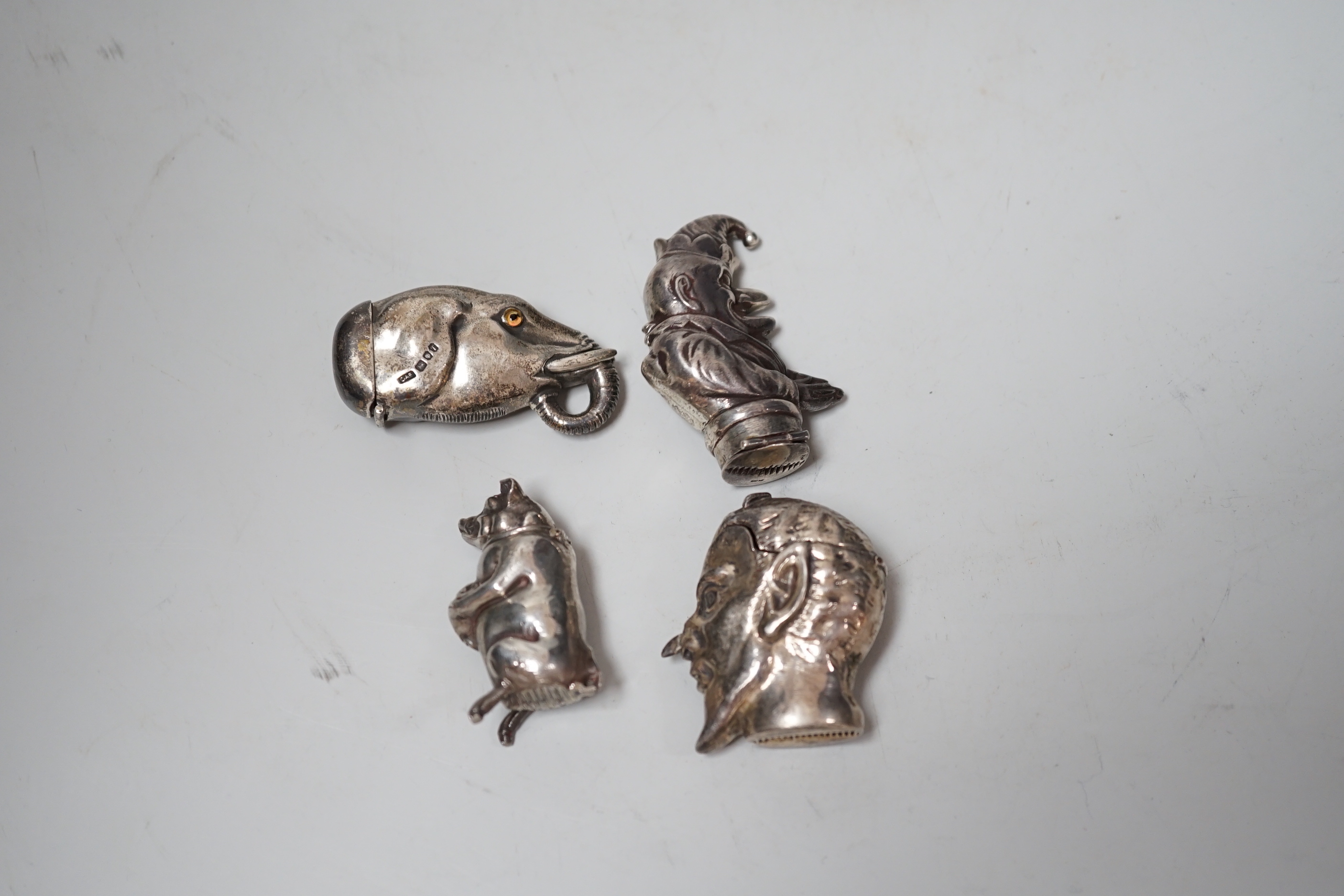 Four assorted modern silver figural vesta case including elephant, bear and Mr. Punch, largest 57mm.